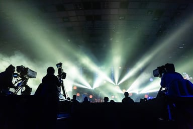 silhouetted cameramen at a concert