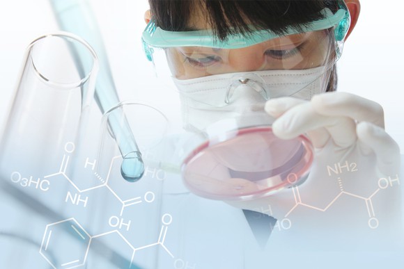 Female scientist holding a petri dish with a dropper, test tubes, and chemical structures appearing in the foreground