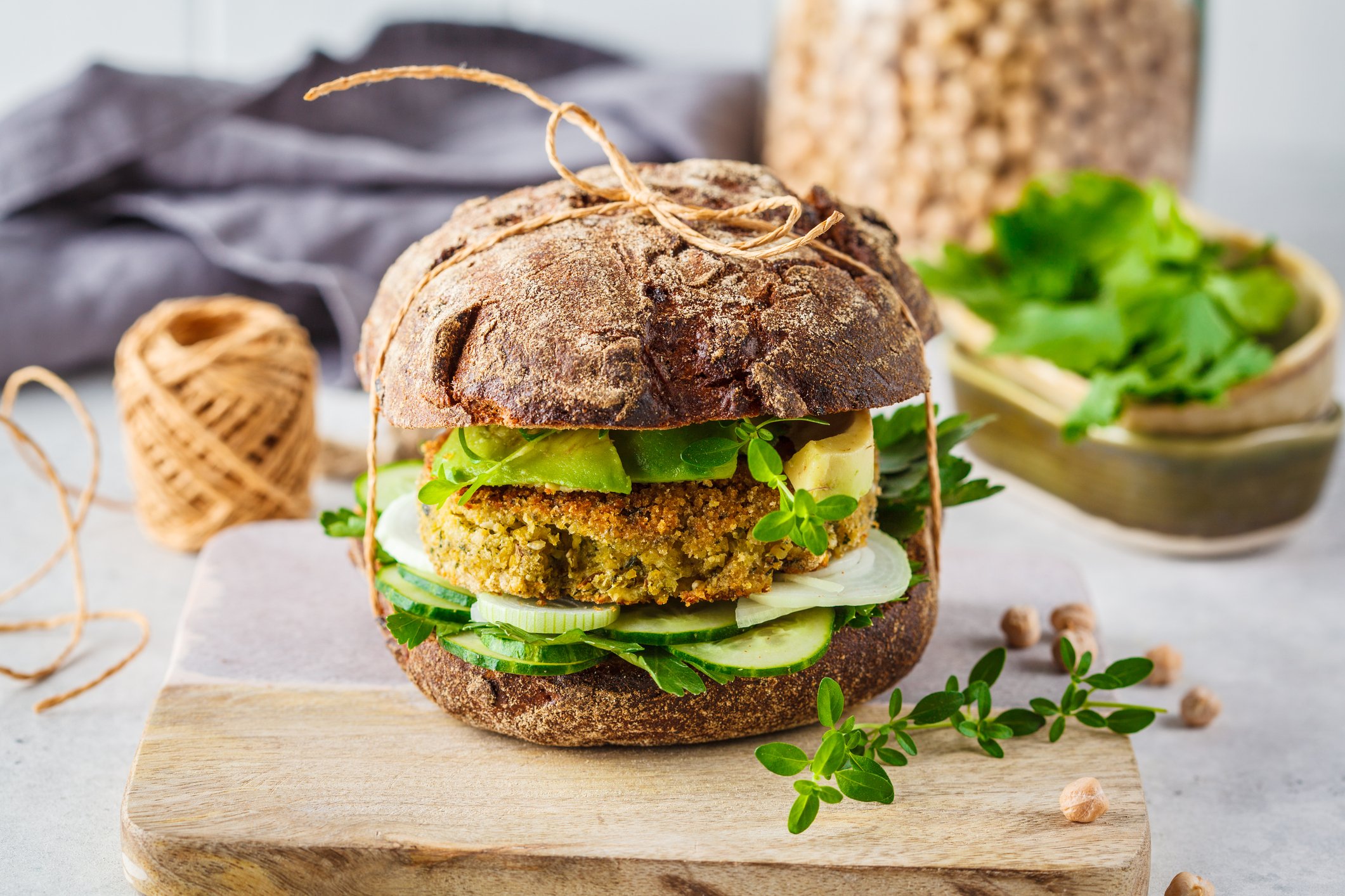 A plant-based burger wrapped with twine.