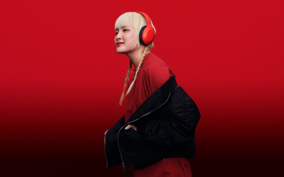 A young woman wears Sony headphones.