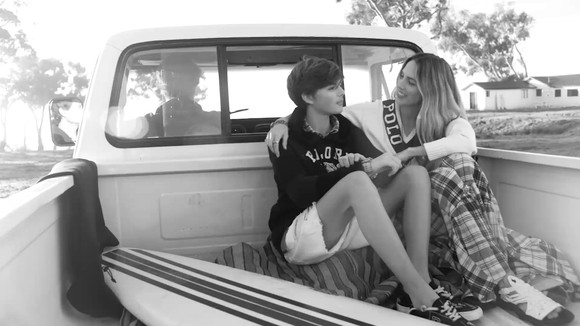 A mother and son wearing Polo clothing in the back of a pickup truck.