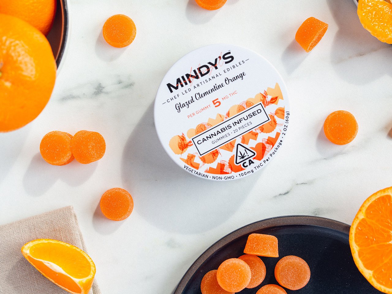 A tin of Mindy's Edibles' Glazed Clementine Orange edibles.