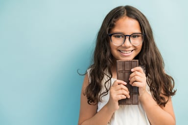 Smiling Girl With Chocolate Bar