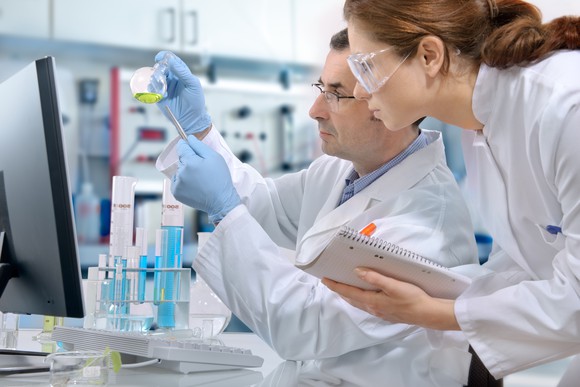 Two researchers study results in a laboratory. 