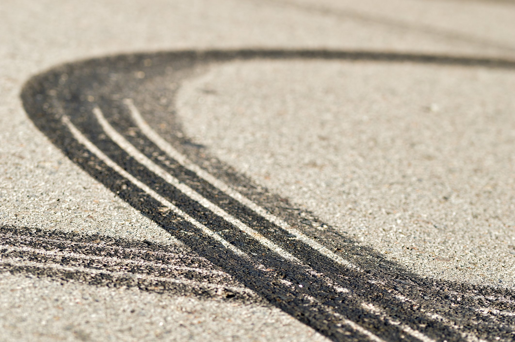 Two car tire skid marks on a road.