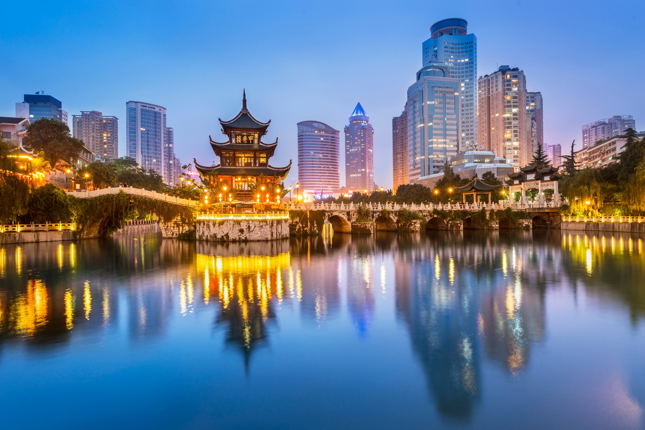 Skyline of a city and Asian temple along the waterfront.