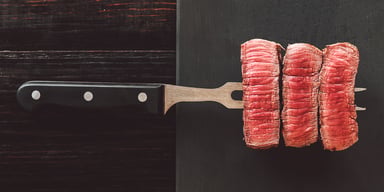 Three pieces of meat on a skewering fork