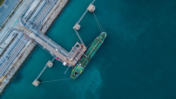 A bird's eye view of an LNG carrier at port.