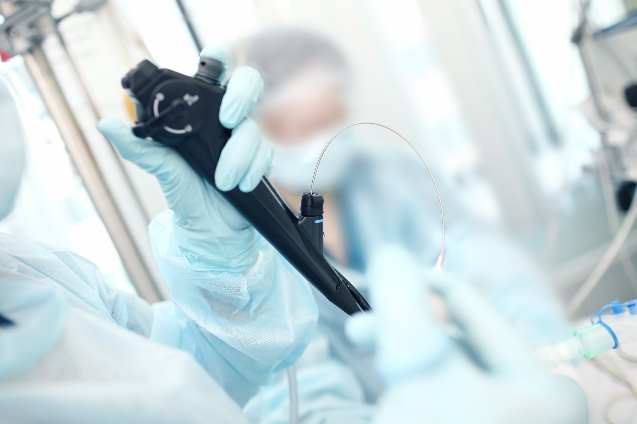 In an operating room, a doctor holds a device used for endoscopy.
