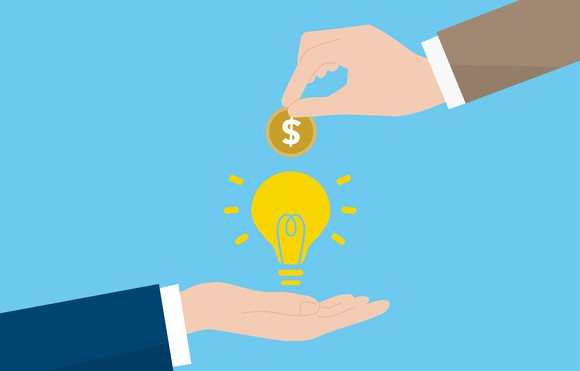 Venture capital concept: Illustration of a hand extending a dollar coin over a hand holding a light bulb.