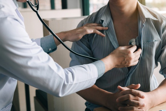 Doctor listening to a patient's chest with a stethoscope
