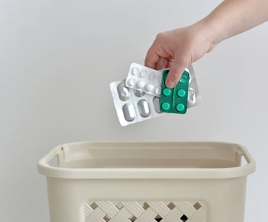 Drugs being thrown in the trash