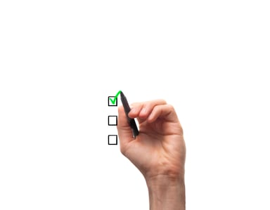 Hand holding pen checking off box