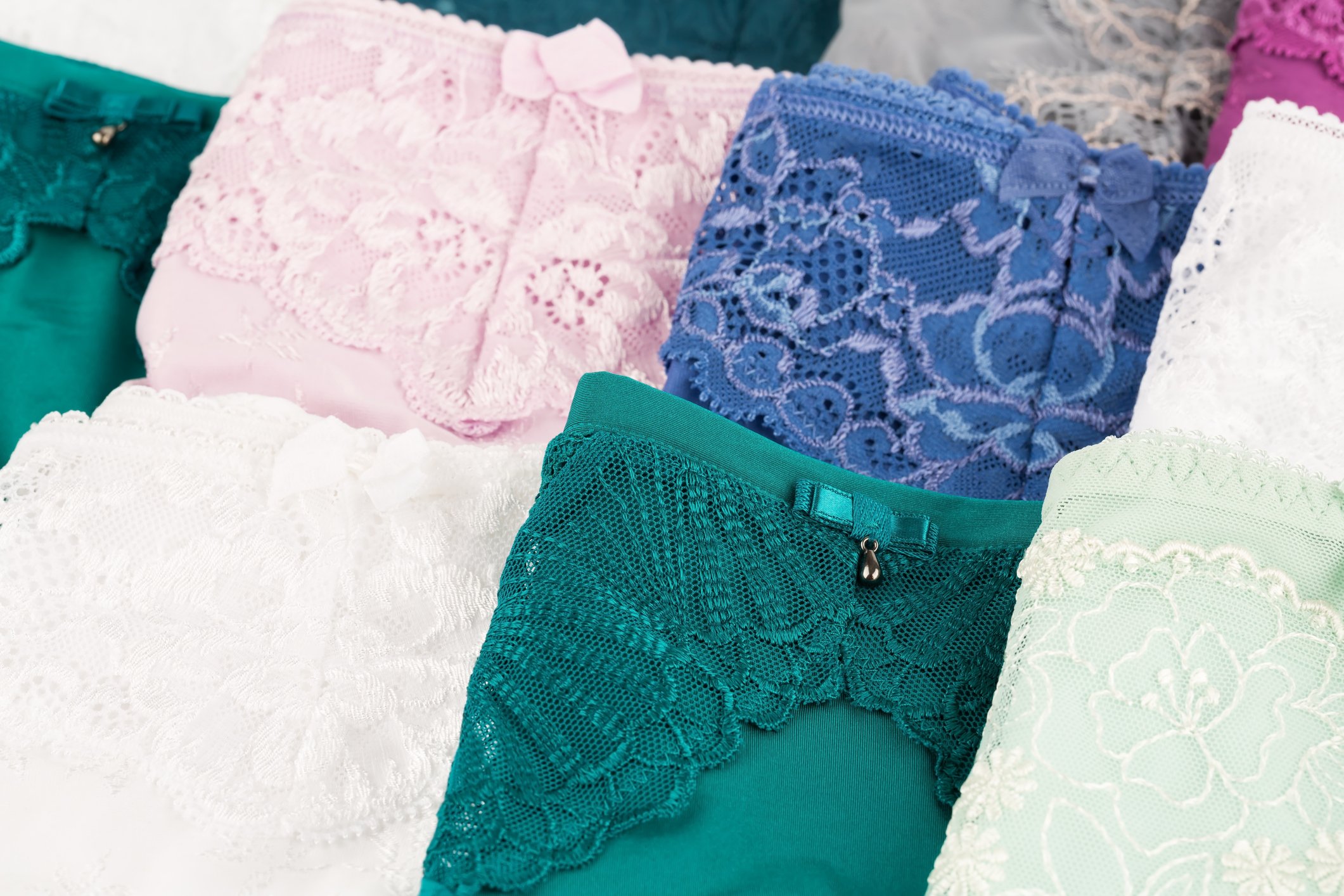 Folded colorful lace underwear displayed in two rows. 