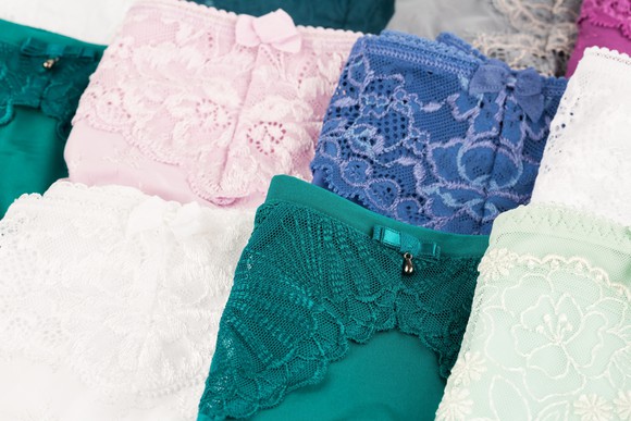 Folded colorful lace underwear displayed in two rows. 