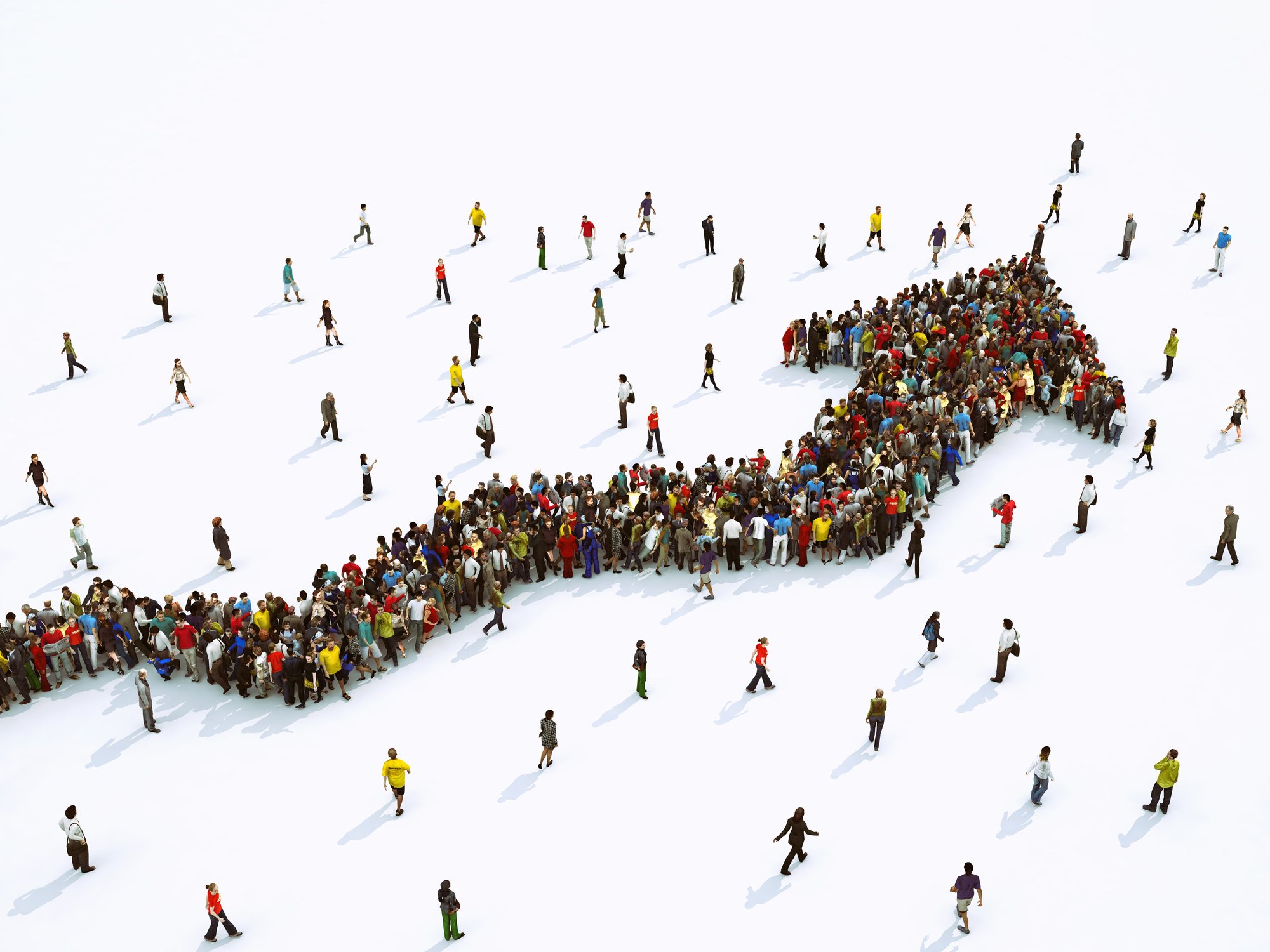 Photograph of many people coming together in the shape of an arrow.