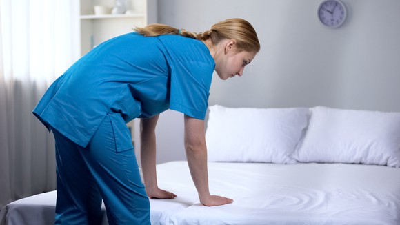 Nurse making a bed