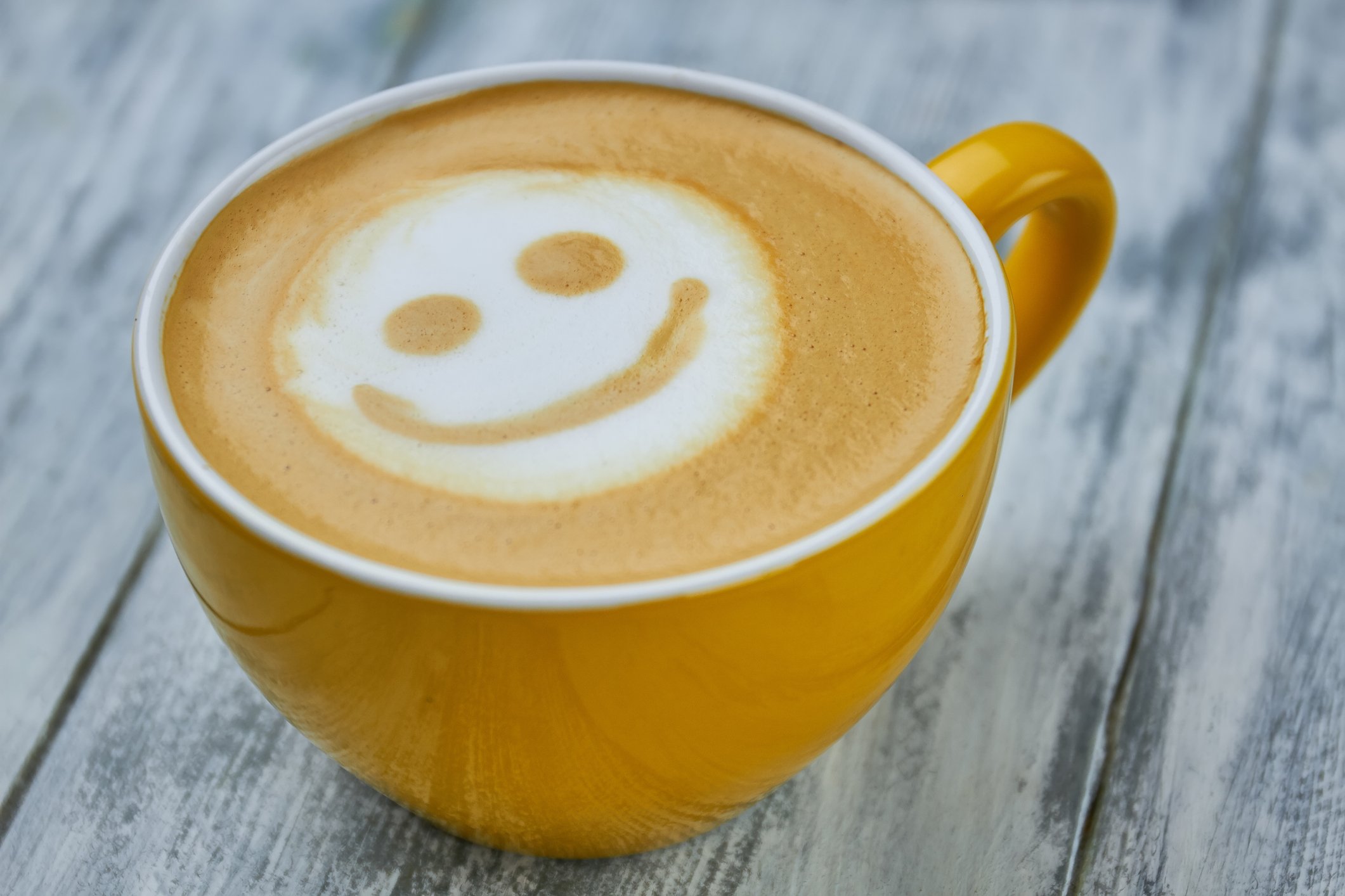 A latte with a smiley face in its foam.