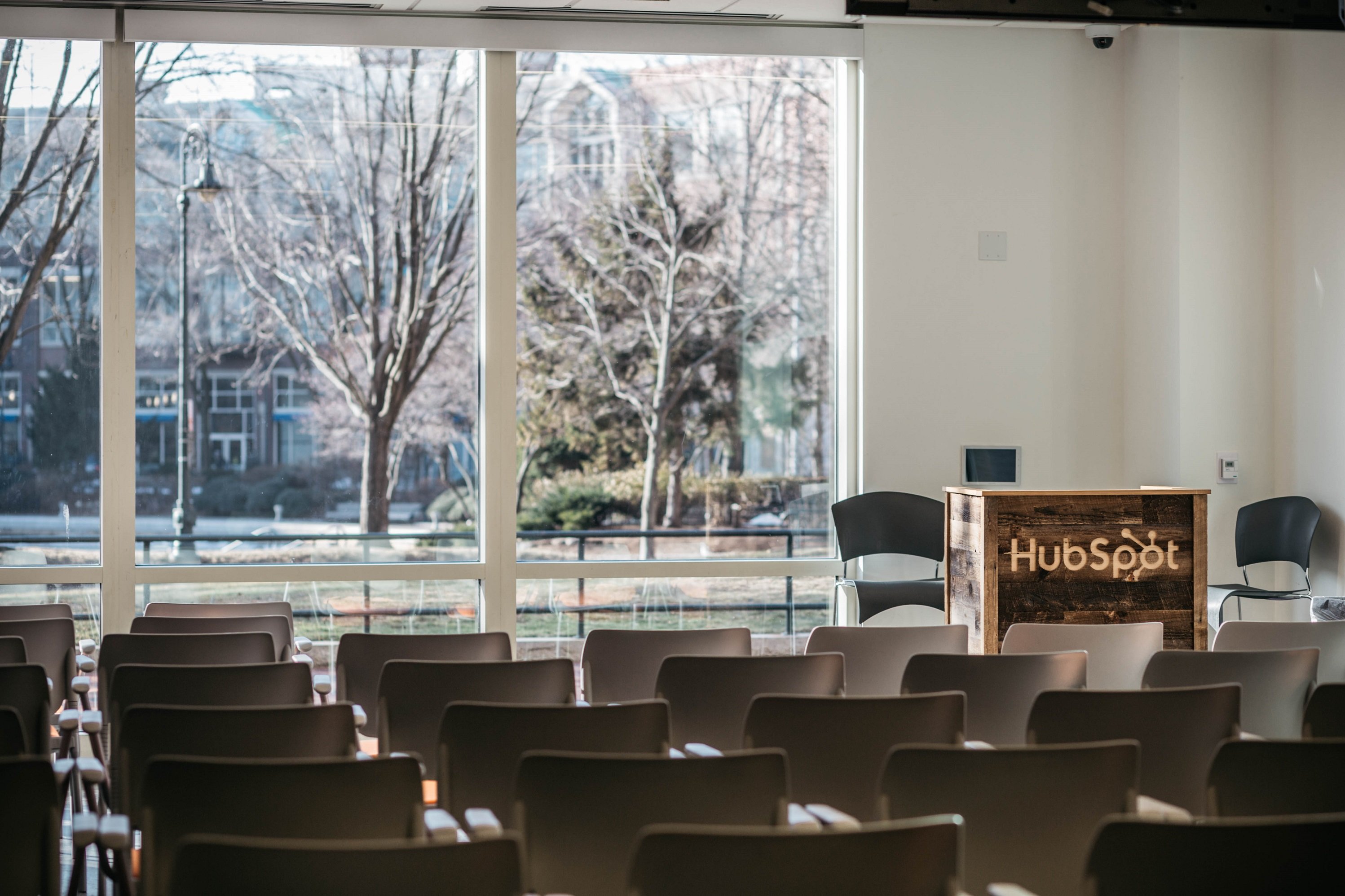 A podium displaying the HubSpot logo in a room set up for a speech