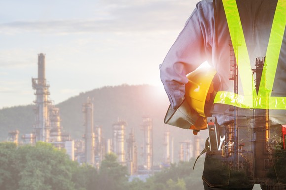 A worker stands in front of an energy project.
