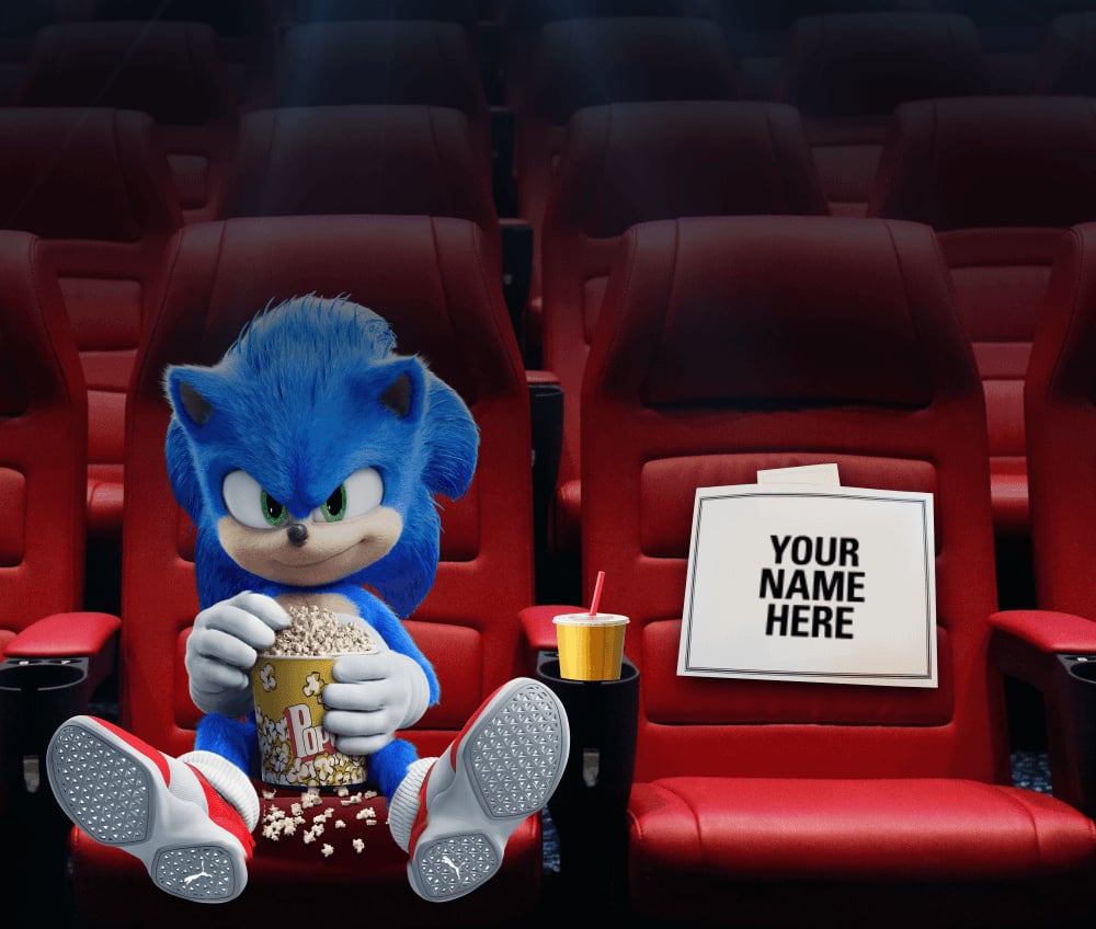 Rendering of Sonic the Hedgehog eating popcorn in an otherwise empty movie theater. The seat next to Sonic holds a sign, saying Your Name Here.