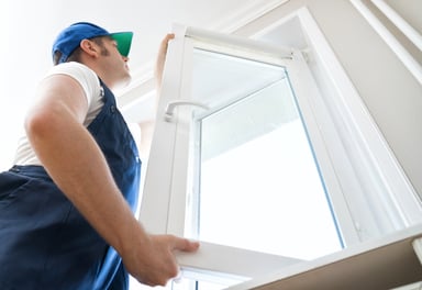 A person installing a new window.