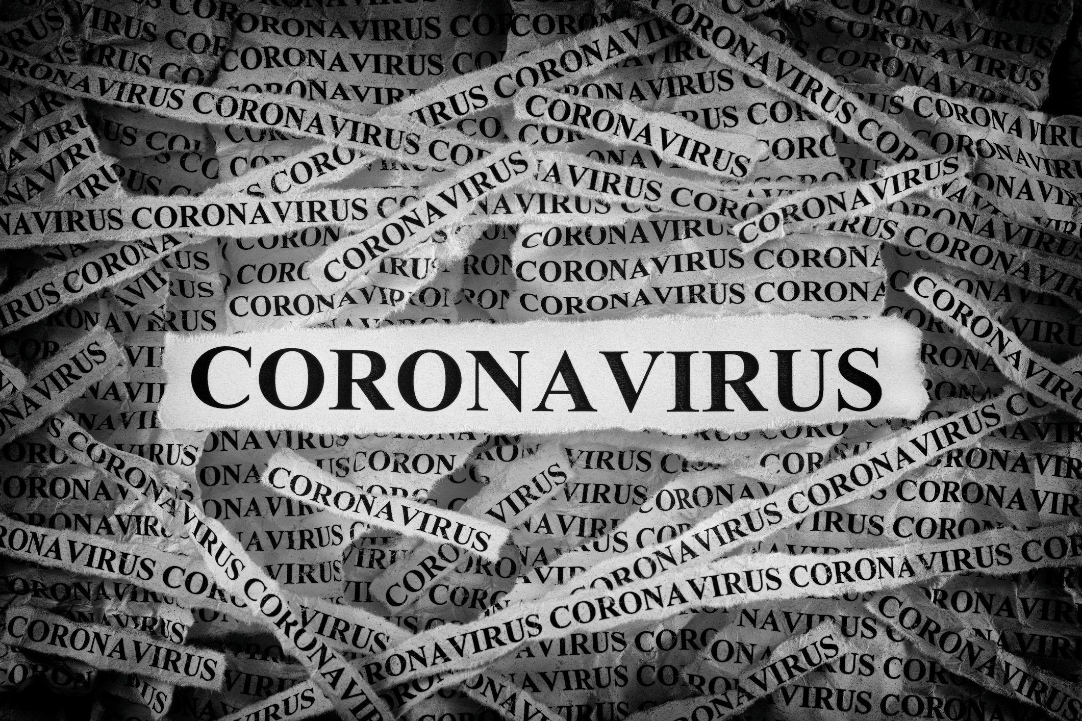 Many strips of newsprint all reading CORONAVIRUS