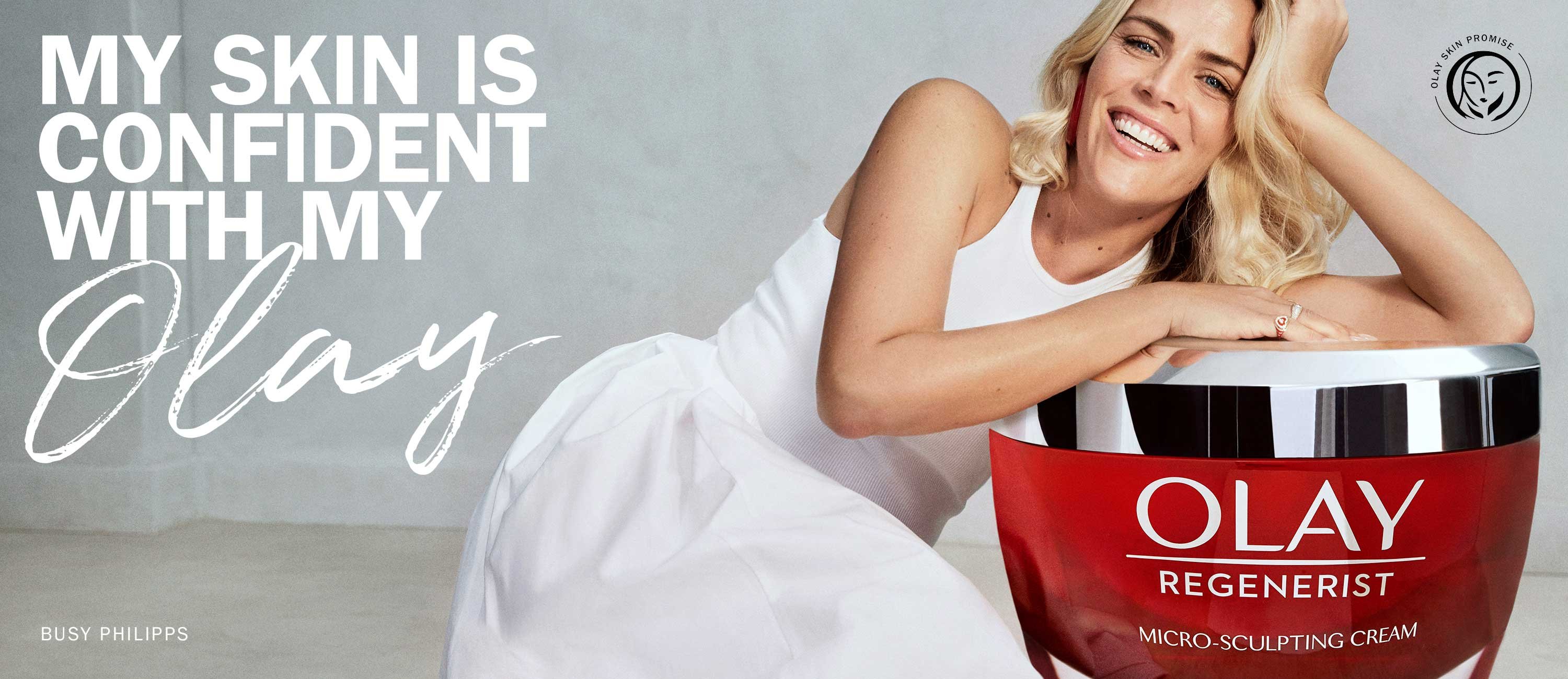 Actress Busy Philipps in an ad for Olay Regenerist skin cream, along with the brand's 'Skin Promise' mark and the text 'My skin is confident with my Olay.'