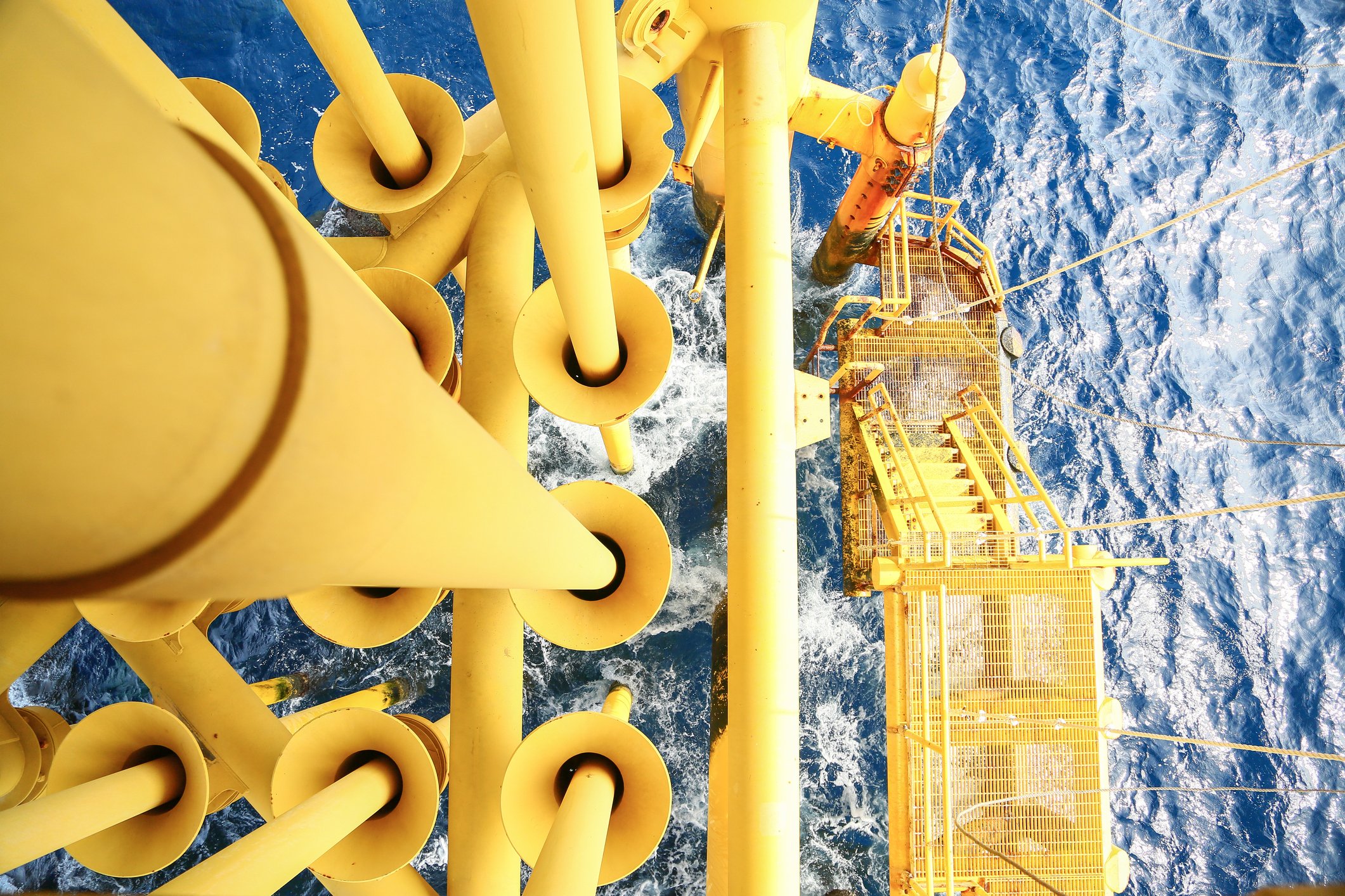 A view of the water and drilling equipment from the platform of an offshore oil rig