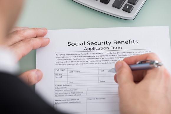 A person fills out a Social Security form. 