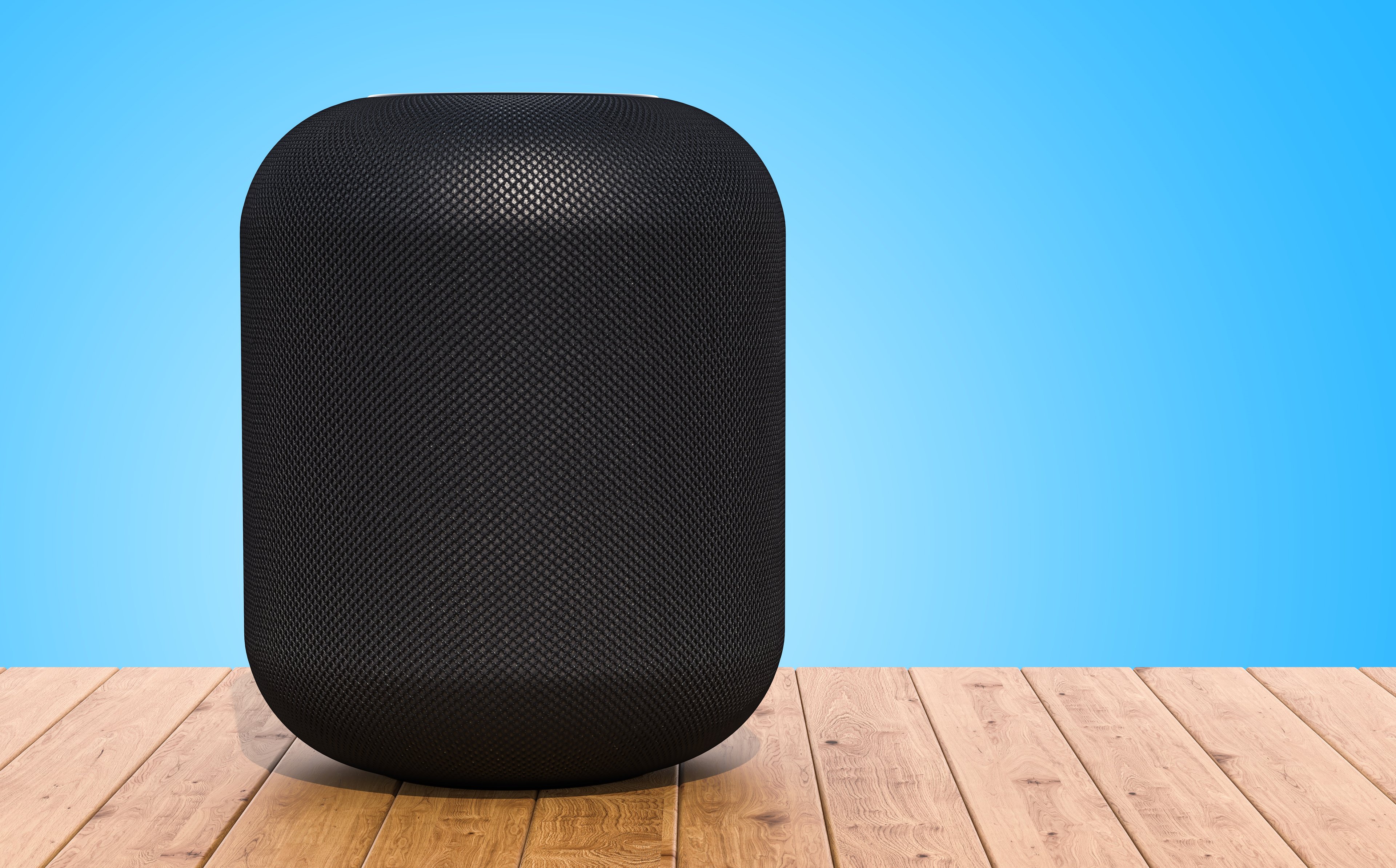 Apple's HomePod on a wood table. 