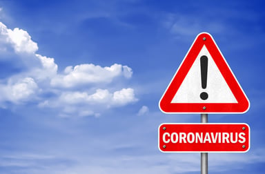 Coronavirus caution printed on a road sign