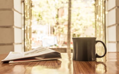 Close-Up of Coffee and Newspaper