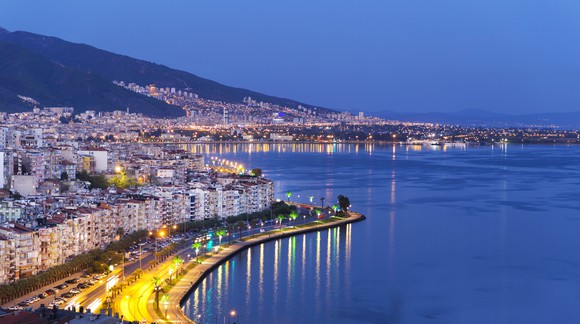The Izmir skyline overlooking the sea at dusk.