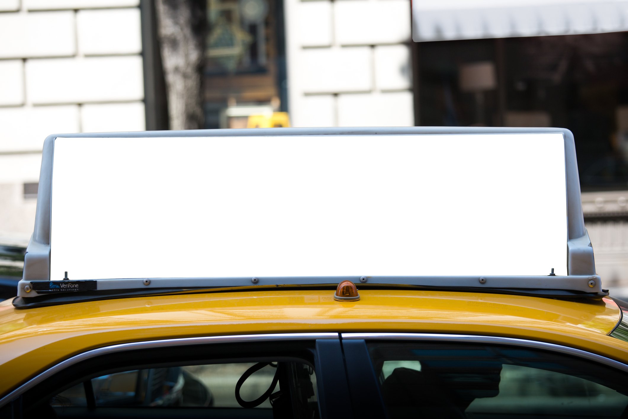 Taxi with a blank ad on its rooftop