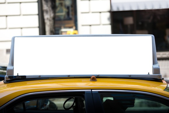 Taxi with a blank ad on its rooftop