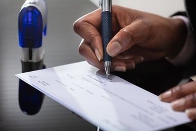 A businessperson signing a check