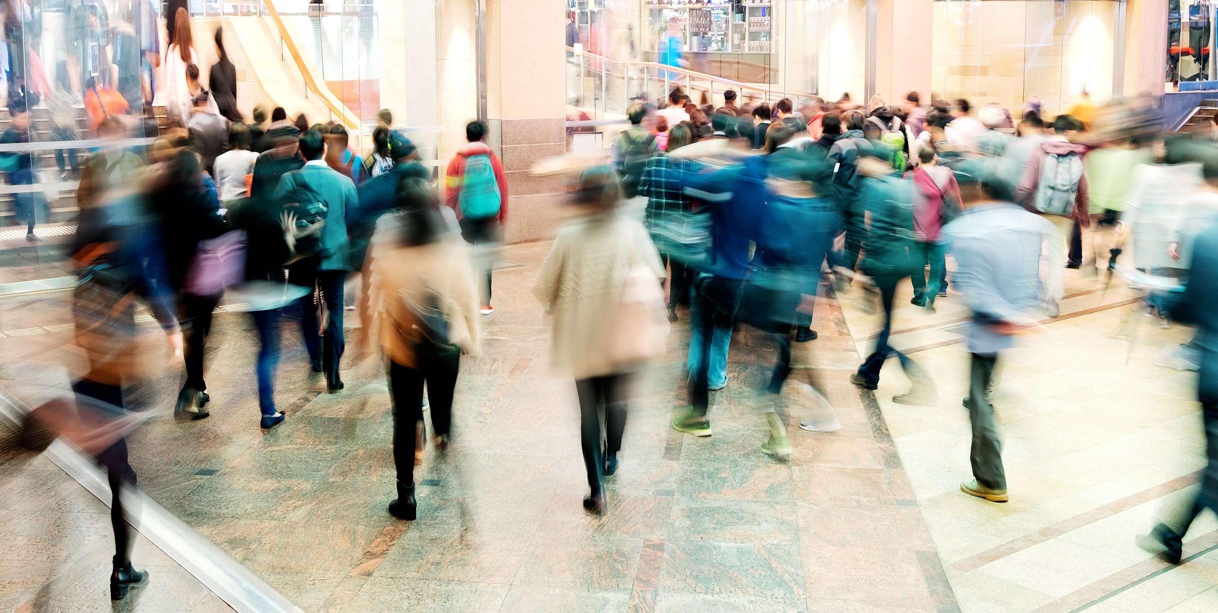 A blurry image of shoppers in a mall