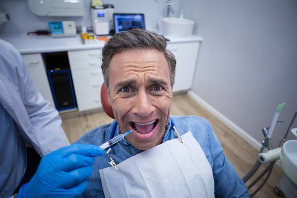 Scared guy at the dentist.