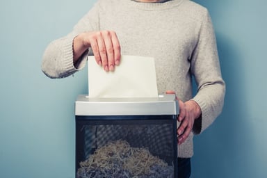 shredding documents in paper shredder