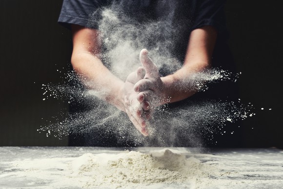 A baker working with flour.