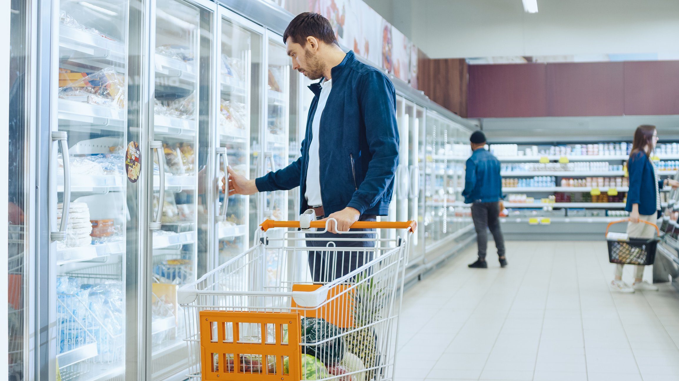 Man shopping in a frozen-food aisle