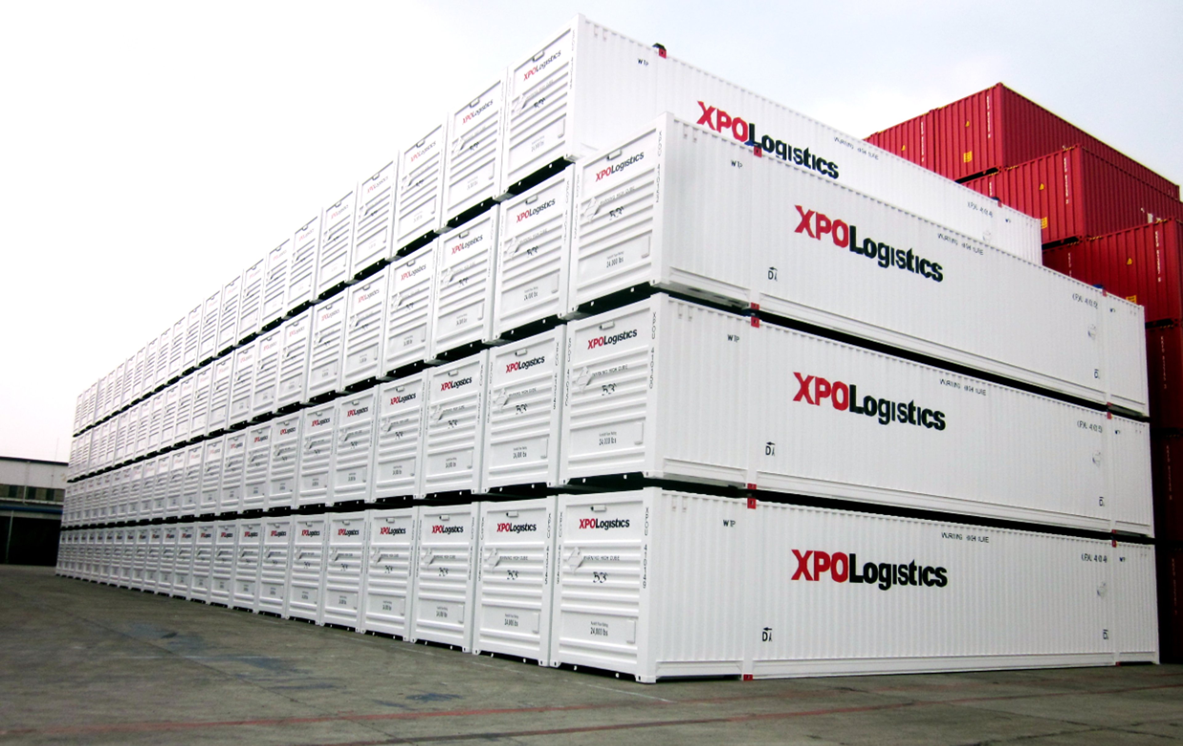 XPO-branded containers stacked at a port facility.
