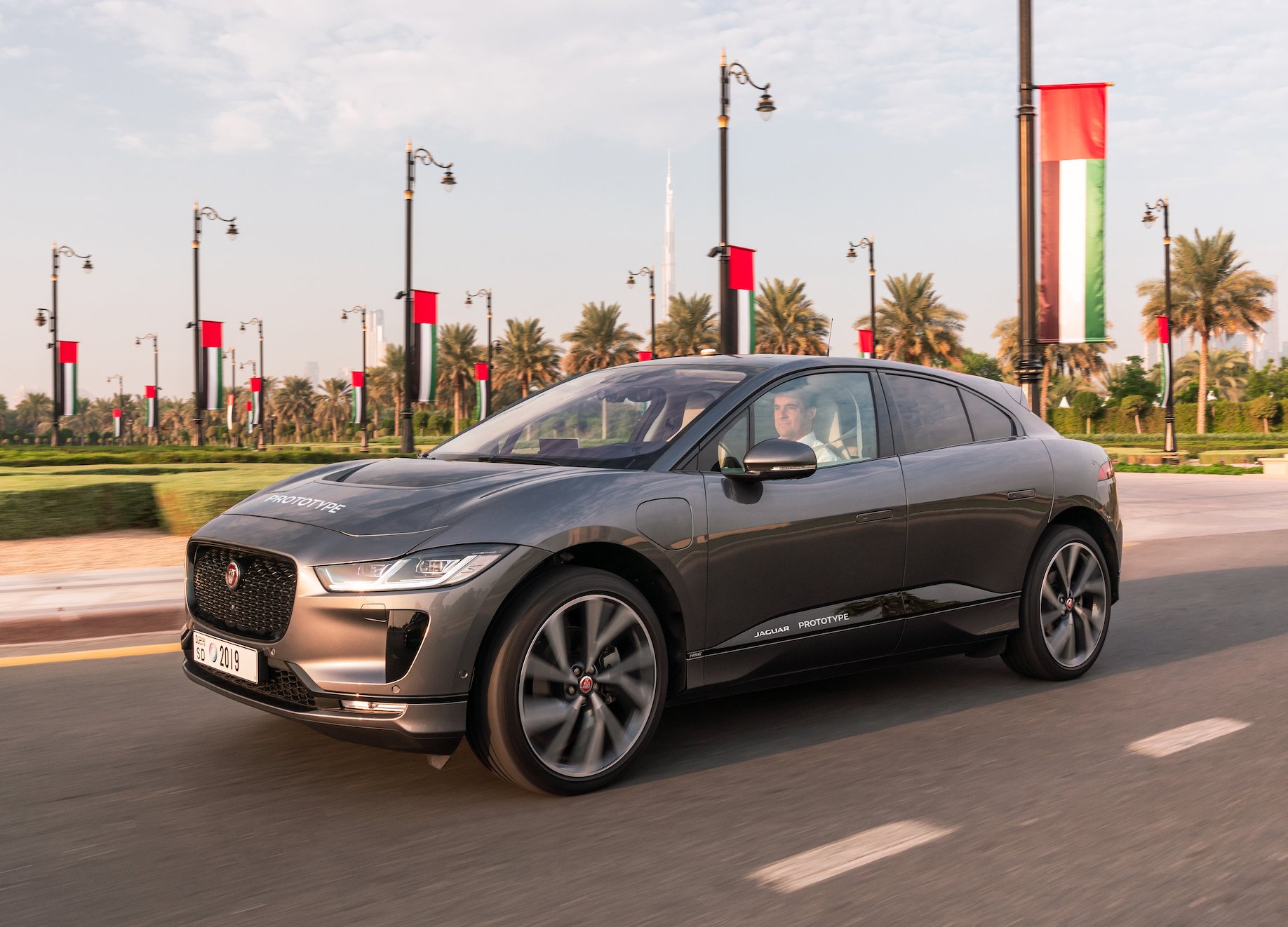 A silver Jaguar I-PACE, an electric luxury crossover SUV.