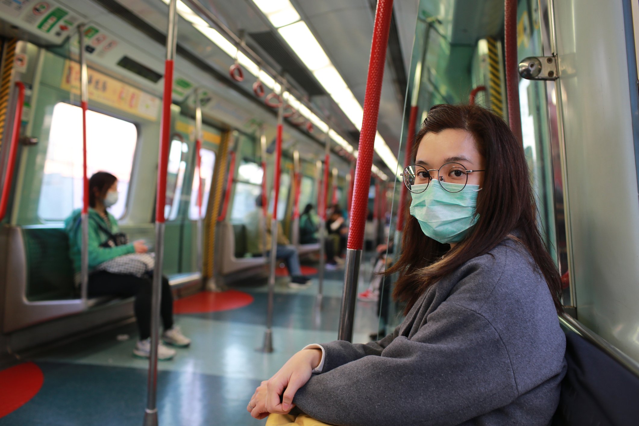 Woman on train wearing surgical mask