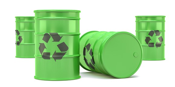 Green barrels with recycling symbols on them.