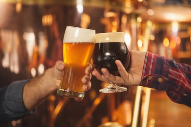 Two men clinking beer glasses