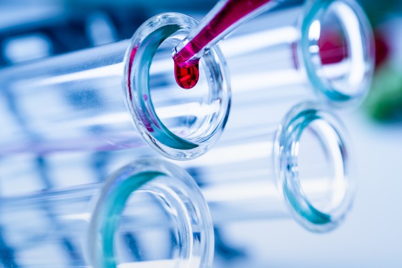 Drop of blood in a test tube with other test tubes close by