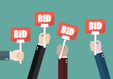 Hands raising auction bid signs