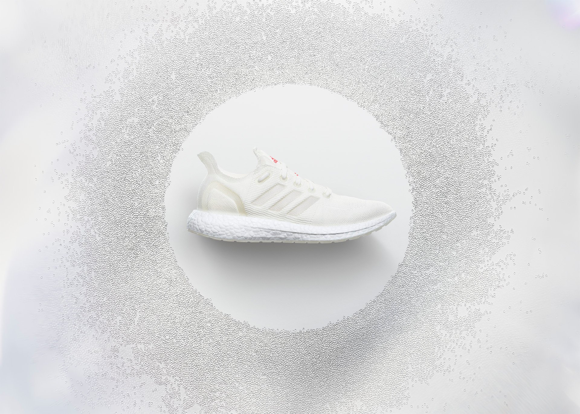 A white sneaker with the Adidas logo on the side.